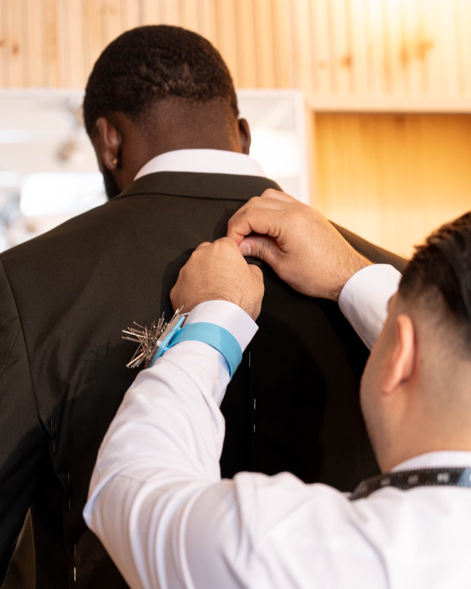 Tailor pinning and adjusting suit with precision